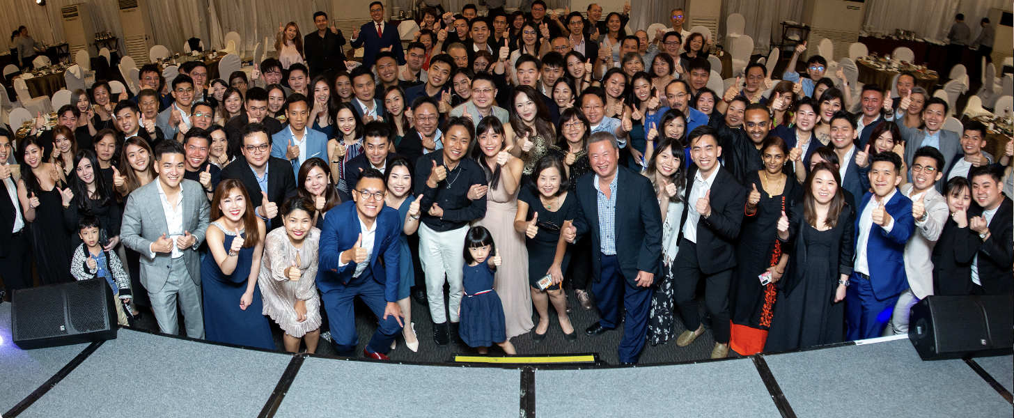 Damien Tan at a client appreciation gala with happy homeowners and investors