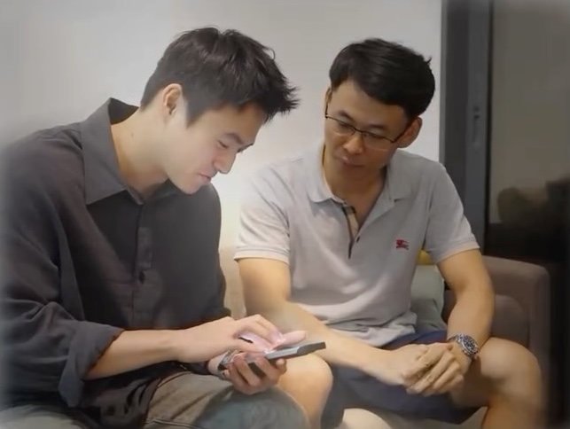 Damien Tan reviewing options with a client on the phone