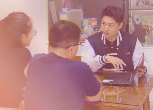 Damien Tan advising a couple at their dining table